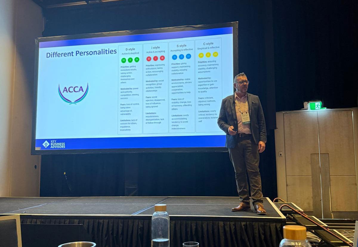 Colin Wilson presenting alongside a slide on personality types