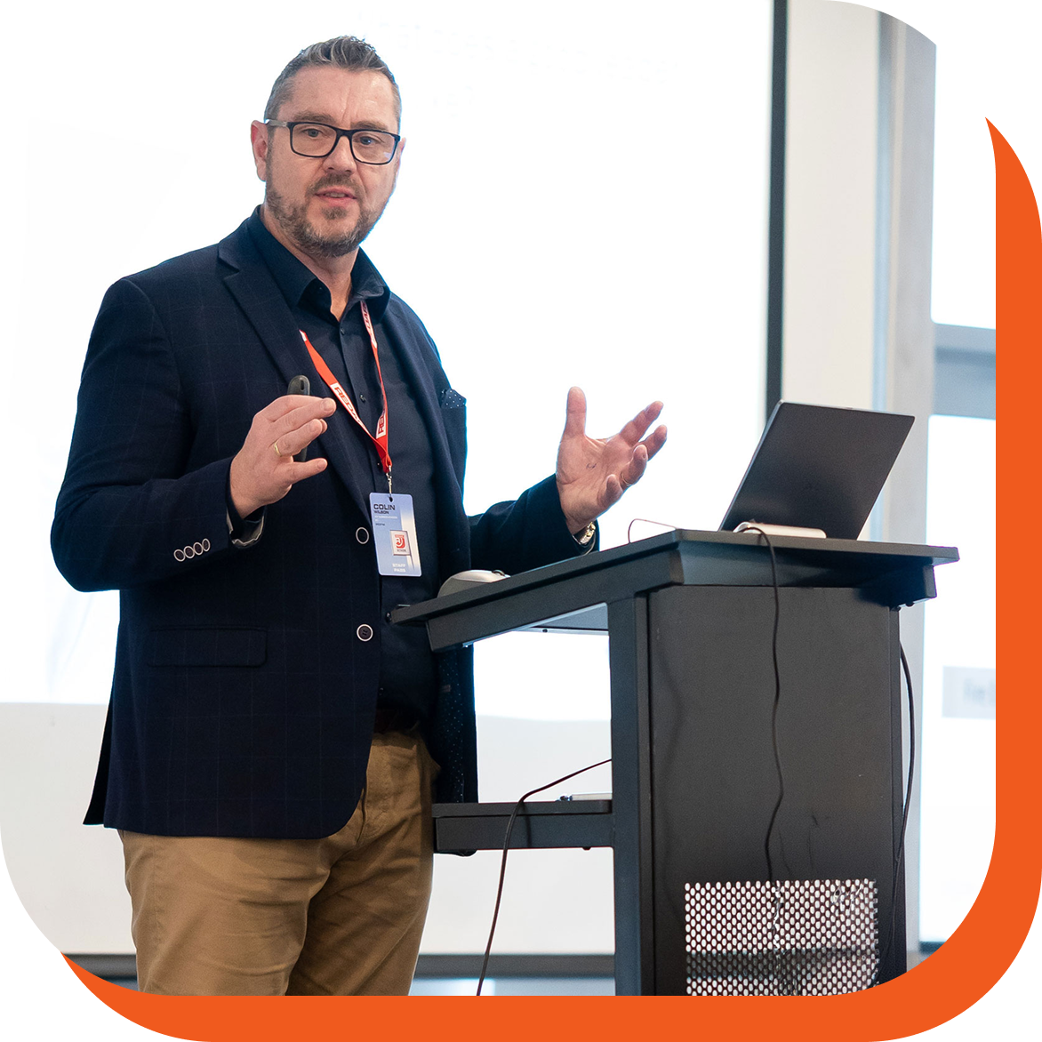 Colin Wilson presenting from a lectern at a conference